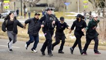 Police, King Soopers employees and customers run down Table Mesa Drive in Boulder after reports of shots fired inside on Monday, March 22, 2021. Ten people were killed by a gunman at the King Soopers supermarket.