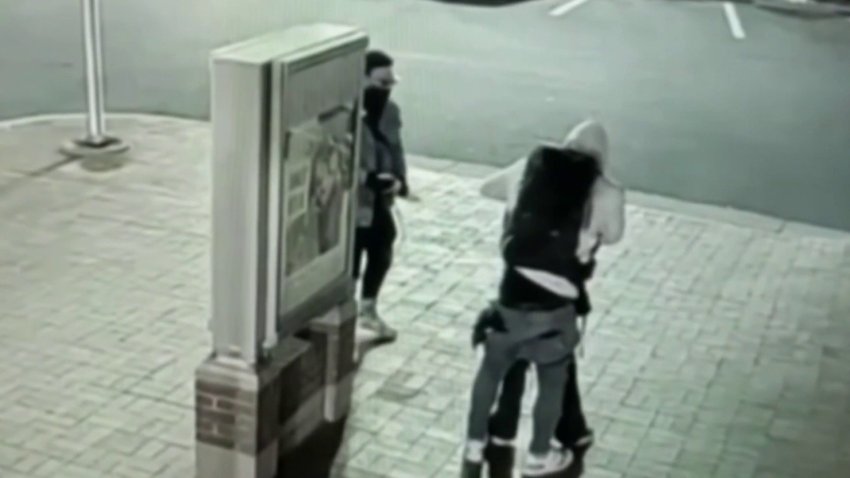 Surveillance video shows two men robbing a woman at knifepoint in Silver Spring.