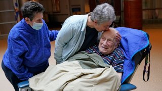 Melvin Goldstein, 90, smiles as his daughter Barbara Goldstein gives him a kiss on the head