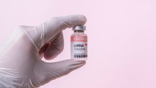 mRNA Vaccine Vial For HIV/AIDS On Pink Background