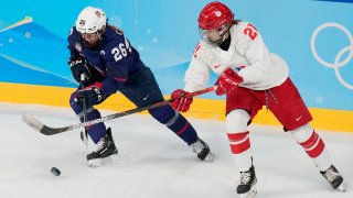 Russian Olympic Committee's Polina Bolgareva (21) and United States' Kendall Coyne Schofield (26) chase the puck during a preliminary round women's hockey game at the 2022 Winter Olympics, Saturday, Feb. 5, 2022, in Beijing.