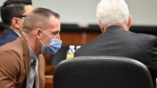 Former Louisville police officer Brett Hankison, left, speaks with his attorney Stewart Mathews