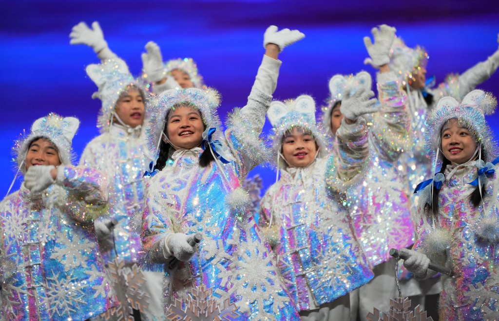 Children bearing snowflakes wave at the audience during the Closing Ceremony at the 2022 Winter Olympic Games, Feb. 20, 2022, in Beijing.