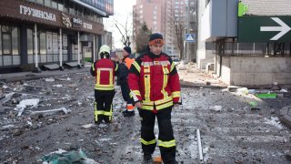 Rescue workers inspect the house in 6A Lobanovsky Avenue which was hit with a missile on Feb. 26, 2022 in Kyiv, Ukraine.