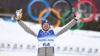 Gold medallist Iivo Niskanen of Team Finland celebrates his win during the Men's Cross-Country Skiing 15km Classic flower ceremony at the 2022 Winter Olympics, Feb. 11, 2022, in Zhangjiakou, China.