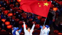 Tingyu Gao of Team China waves the flag of China during the 2022 Winter Olympics Closing Ceremony, Feb. 20, 2022, in Beijing, China.