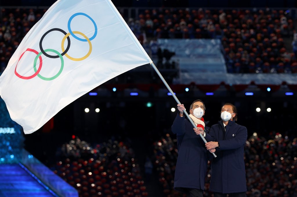 Guiseppe Sala, Mayor of Milano city and Gianpetro Ghedina, Mayor of Cortina d' Ampezzo City wave the Olympic flag during the 2022 Winter Olympics Closing Ceremony, Feb. 20, 2022, in Beijing.