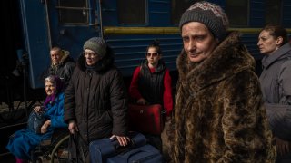 Ukrainians escaping from the besieged city of Mariupol along with other passengers from Zaporizhzhia arrive at Lviv, western Ukraine, on Sunday, March 20, 2022