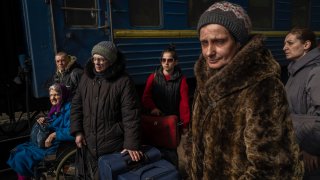 Ukrainians escaping from the besieged city of Mariupol along with other passengers from Zaporizhzhia arrive at Lviv, western Ukraine, on Sunday, March 20, 2022