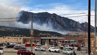 Smoke billows from a wildfire Saturday, March 26, 2022 in Marshall, Colo. a few miles south of Boulder, Colo.