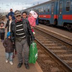 Refugees fleeing the war from neighboring Ukraine walk on a platform after disembarking from a train in Zahony, Hungary, Wednesday, March 2, 2022. At the train station in the Hungarian town of Zahony on Wednesday, more than 200 Ukrainians with disabilities — residents of two care homes in Ukraine's capital of Kyiv — disembarked into the cold wind of the train platform after an arduous escape from the violence gripping Ukraine.