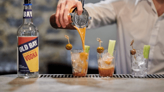 bartender fixing a drink with Old Bay Vodka