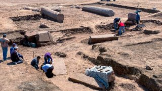 This undated photo provided by the Egyptian Tourism and Antiquities Ministry on Monday, April 25, 2022, shows archeologists working in the ruins of a temple for Zeus-Kasios, the ancient Greek god, at the Tell el-Farma archaeological site in the northwestern corner of the Sinai Peninsula