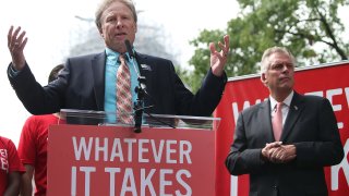 Andy Parker (L), father of murdered TV reporter Alison Parker, speaks while flanked by then-Gov. Terry McAuliffe (D-Virginia), during an anti-gun rally on Capitol Hill, Sept. 10, 2015 in Washington, D.C.