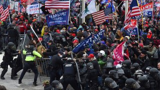 FILE - Trump supporters clash with police and security forces as they push barricades to storm the U.S. Capitol in Washington, D.C., on Jan. 6, 2021.