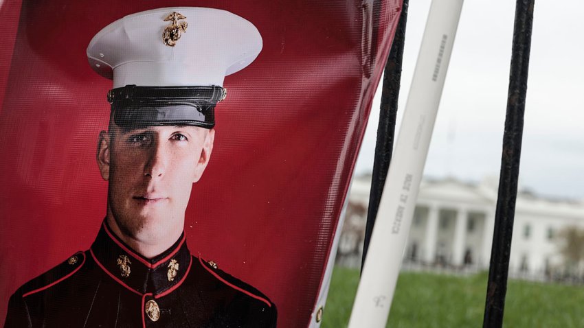 FILE - A banner with a picture of Trevor Reed, a U.S. Marine who was detained in a Russian prison, hangs in Lafayette Park near the White House as his parents Joey and Paula Reed demonstrate on March 30, 2022, in Washington, D.C.