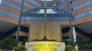 FILE - A cross and Bible sculpture stand outside the Southern Baptist Convention headquarters in Nashville, Tenn., on Tuesday, May 24, 2022.