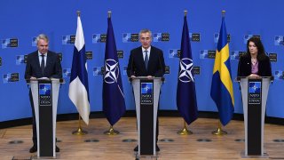 NATO Secretary General Jens Stoltenberg (C), Finland Ministers for Foreign Affairs Pekka Haavisto (L) and Sweden Foreign minister Ann Linde (R)