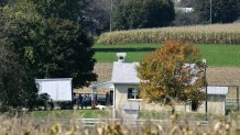 Investigators search the one-room West Nickel Mines Amish Schoo