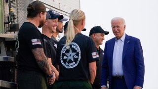 President Joe Biden greets firefighters as he tours the National Interagency Fire Center