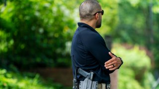 A U.S. Marshal patrols outside the home of Supreme Court Justice Brett Kavanaugh, in Chevy Chase, Md., Wednesday, June 8, 2022. Officials say an armed man who threatened to kill Justice Brett Kavanaugh was arrested near the justice’s house in Maryland. A law enforcement official says the California man in his 20s was armed with a gun and a knife.