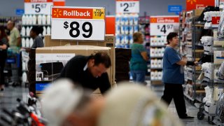 Walmart Rollback pricing signs are displayed while customers shop during the grand opening of a new Wal-Mart Stores location in Torrance, California.