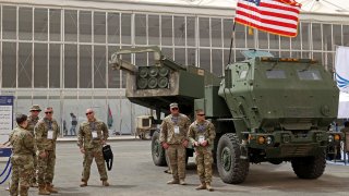 US military personnel stand by a M142 High Mobility Artillery Rocket System (HIMARS) during Saudi Arabias first World Defense Show, north of the capital Riyadh, on March 6, 2022.