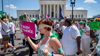 Mahayana Landowne, of Brooklyn, N.Y., wears a “Lady Justice” costume as she marches past the Supreme Court during a protest for abortion-rights, Thursday, June 30, 2022, in Washington.