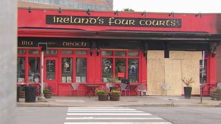 Ireland’s Fourt Courts pub was boarded up the Monday after a car crashed into the building, injuring 15 people, police said.