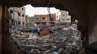 Palestinians inspect their house which was hit by an Israeli airstrike in Gaza City, Monday, Aug. 8, 2022.