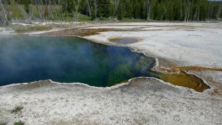 In this photo provided by the National Park Service is the Abyss Pool hot spring in the southern part of Yellowstone National Park, Wyo., in June 2015.