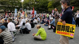 Protesters gather a park in Tokyo Friday, Sept. 23, 2022,