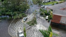 In this aerial view, vehicles make their way through a flooded area after Hurricane Ian passed through on September 29, 2022 in Fort Myers, Florida. The hurricane brought high winds, storm surge and rain to the area causing severe damage.