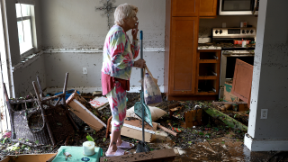 Stedi Scuderi looks over her apartment after flood water inundated it when Hurricane Ian passed through the area on September 29, 2022 in Fort Myers, Florida.