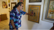 Steven Chavez shows his own artwork hanging on the walls of his Palm Springs home