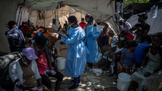 Medical personnel attend patients with cholera symptoms