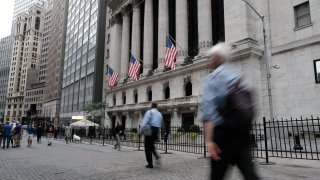 People walk by the NYSE in New York City.