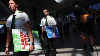 Delta Airlines pilots make their way to Terminal 4 to picket for a new contract at JFK International Airport on September 01, 2022 in New York City.