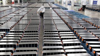 This image, from March 2021, shows a worker with car batteries at a facility in China.