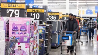 Shoppers walk the aisles of Wal-Mart for Black Friday deals on November 25, 2022 in Dunwoody, Georgia. Walmart opened at 6am on Black Friday for shoppers. 