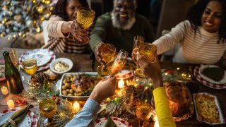 Family toasting on Christmas dinner at home