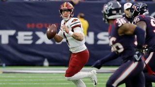 HOUSTON, TEXAS – NOVEMBER 20: Taylor Heinicke #4 of the Washington Commanders scrambles out of the pocket in the first quarter of a game against the Houston Texans at NRG Stadium on November 20, 2022 in Houston, Texas. (Photo by Bob Levey/Getty Images)