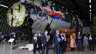 FILE - Judges and lawyers view the reconstructed wreckage of Malaysia Airlines Flight MH17, at the Gilze-Rijen military Airbase, southern Netherlands, on May 26, 2021.