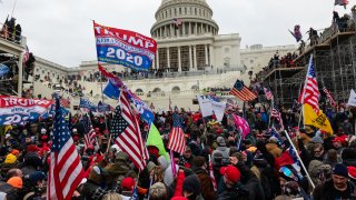 Demonstrators attempt to enter the U.S. Capitol building during a protest in Washington, D.C., U.S., on Wednesday, Jan. 6, 2021. The U.S. Capitol was placed under lockdown and Vice President Mike Pence left the floor of Congress as hundreds of Demonstrators swarmed past barricades surrounding the building where lawmakers were debating Joe Biden’s victory in the Electoral College. Photographer: Eric Lee/Bloomberg via Getty Images
