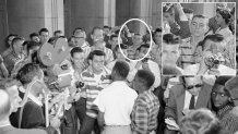 A Sept. 9, 1957, AP Photo shows Dallas Cowboys owner Jerry Jones in the background of a group of defiant white students at Arkansas' North Little Rock High School blocking the doors of the school, denying access to six African-American students enrolled in the school. Moments later the African American students were shoved down a flight of stairs and onto the sidewalk, where city police broke up the altercation.