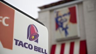 Signage is displayed outside a Yum! Brands Inc. Taco Bell restaurant in Lockport, Illinois.