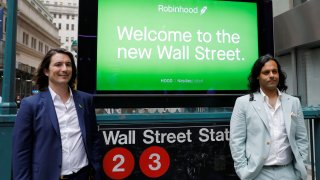 Robinhood Markets, Inc. CEO and co-founder Vlad Tenev and co-founder Baiju Bhatt pose with Robinhood signage on Wall Street after the company’s IPO in New York City, U.S., July 29, 2021.