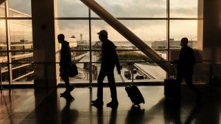 Travelers walk through the Detroit Metropolitan Wayne County Airport in Detroit on Nov. 21, 2021.