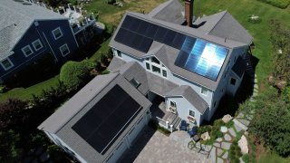 Solar panels create electricity on the roof of a house in Rockport, Massachusetts, U.S., June 6, 2022. Picture taken with a drone.