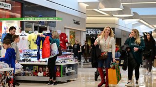 Shoppers carry bags of purchased merchandise at the King of Prussia Mall on December 11, 2022 in King of Prussia, Pennsylvania.